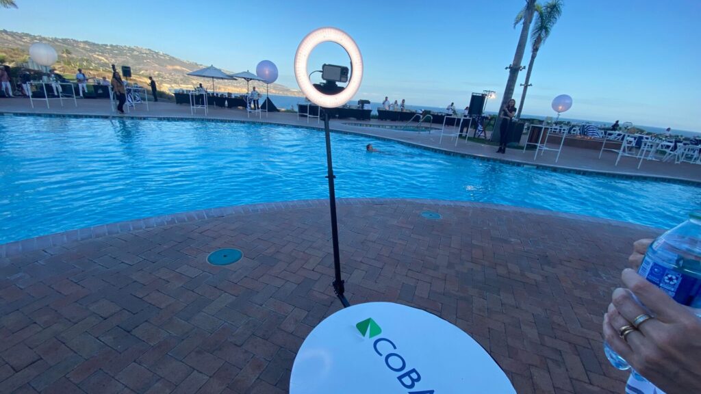 The 360 photo stand in front of a pool at the CoBank event