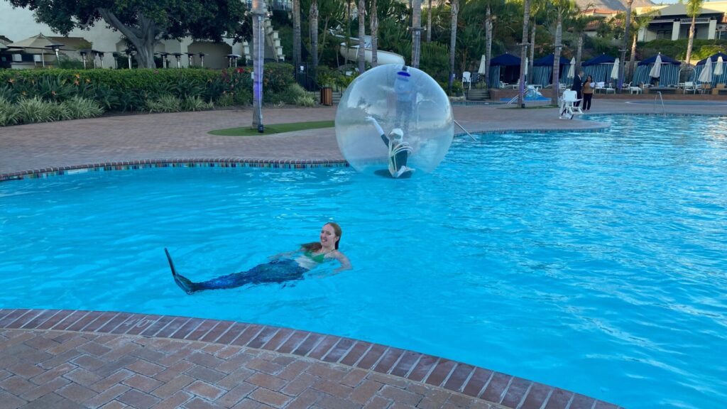 Some characters enjoy the pool at the CoBank party