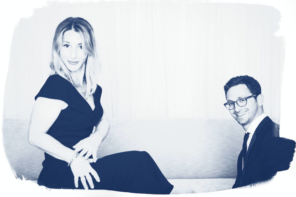A man and woman are posed in a fashion style