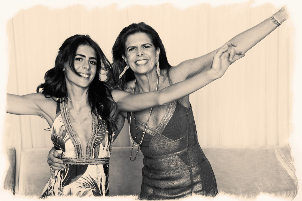 Two women do a silly pose in the photo booth