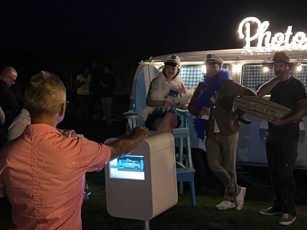 People post in front of the VW Bus at the Intuit Event